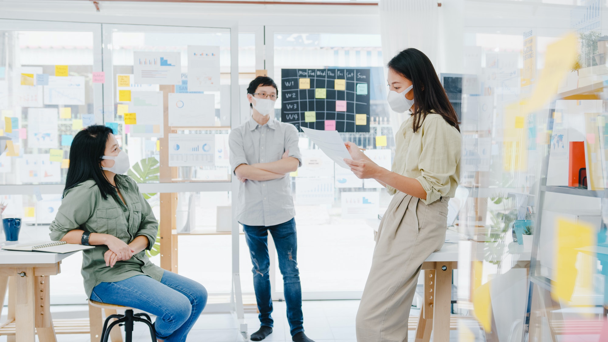 Asia businesspeople meeting ideas project colleagues and wear protective face mask at office.